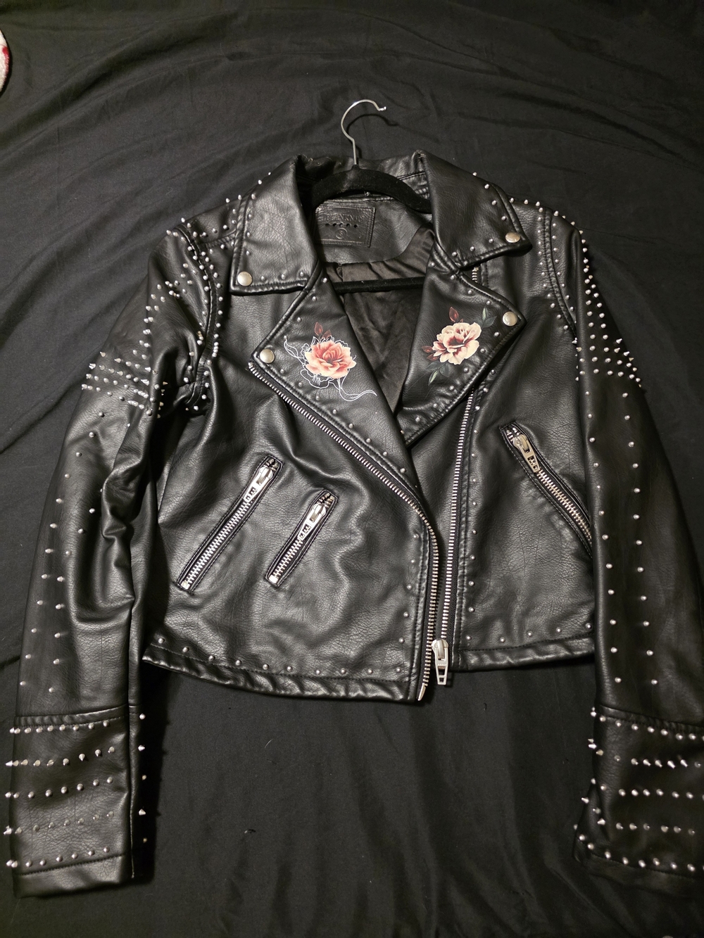 Blank NYC Black Studded Faux Leather Moto Jacket with Rose Details